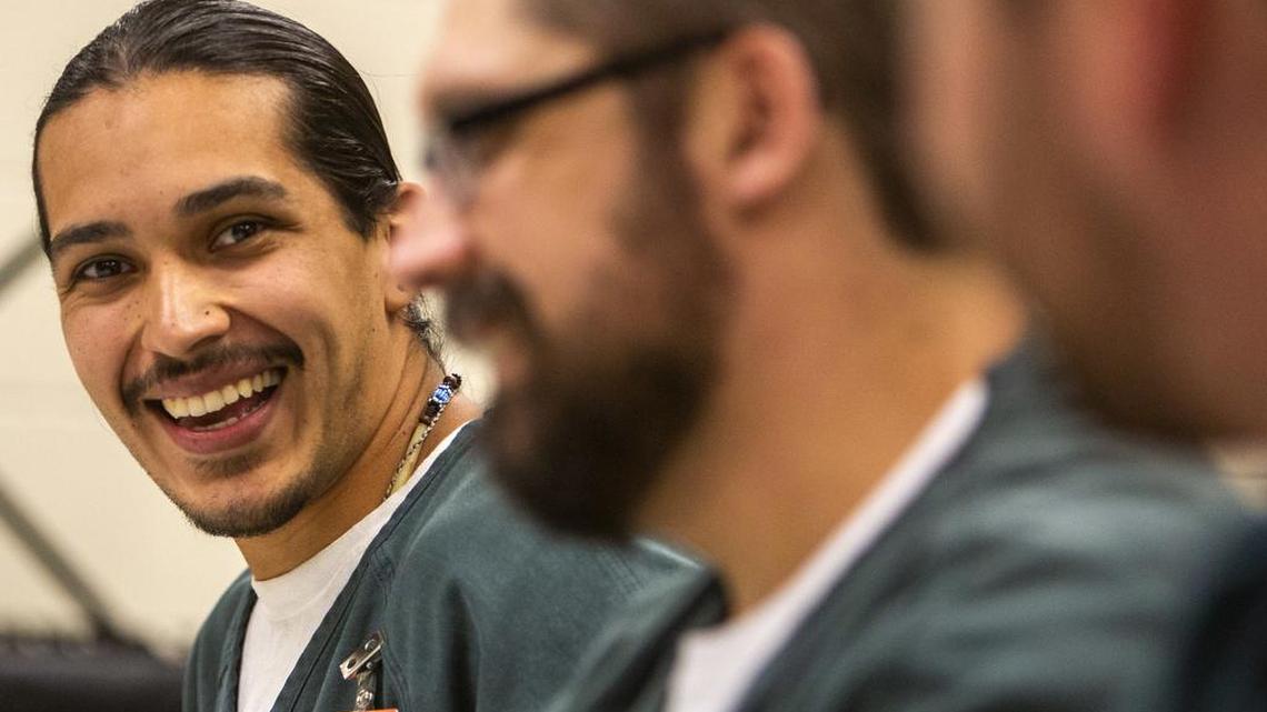 Daniel Alonzo, left, swaps ideas with fellow inmates during their creative writing class.