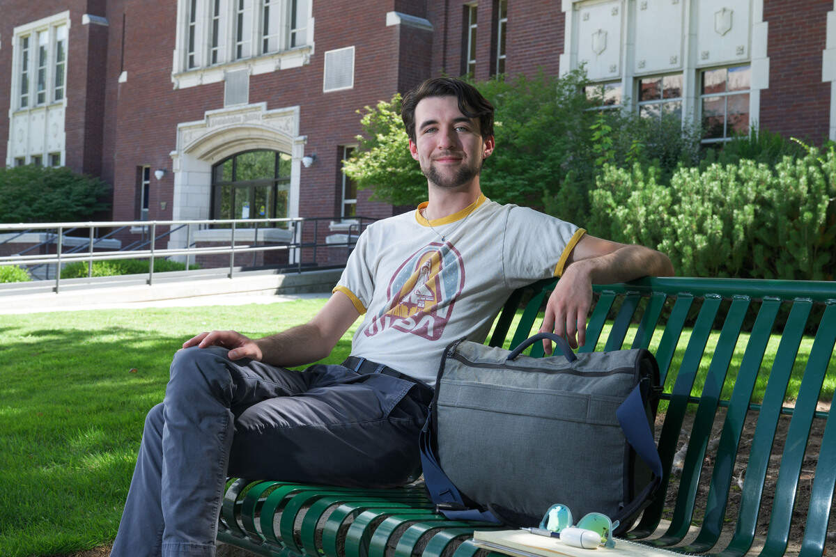 Ian Peña, an engineering student, sits outside Boise State’s Administration Building.