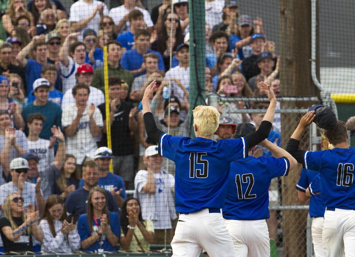 Timberline senior Tomas Vizgirdas (15) celebrates with the Wolves' crowd after winning the 5A baseball state championship Saturday.