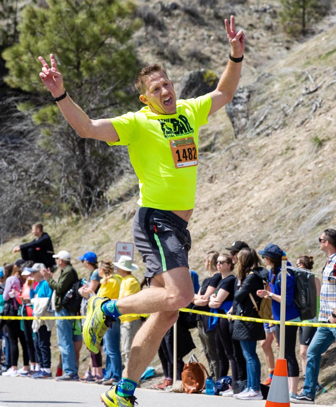 Race to Robie Creek runner Lars Dorr takes a jumping pose at the finish line.