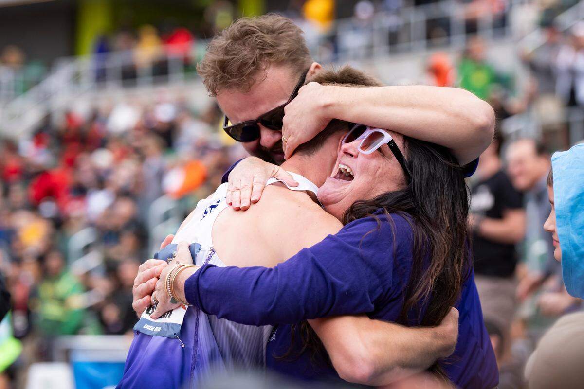 Nathan Green is embraced by his parents April Nezirevic, right, and Admir Nezvirec after winning the men's 1,500 meters on day three of the NCAA Outdoor Track and Field Championships on June 13, 2025, at Hayward Field in Eugene.
