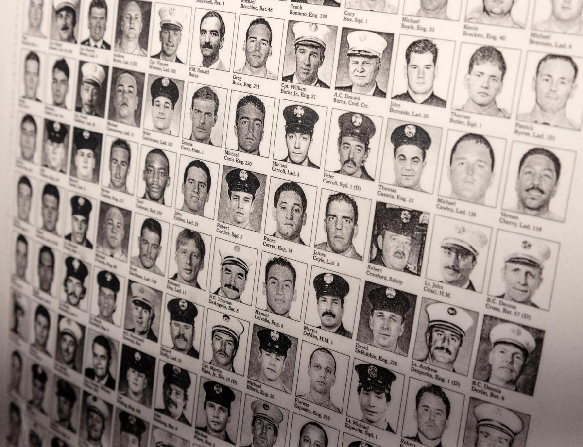 Photographs of first responders killed in the 9/11 terrorist attacks are displayed at a ceremony at The Idaho Fallen Firefighters Memorial in Boise on Saturday morning.