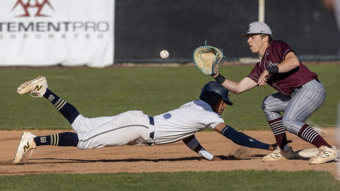 Middleton senior DJ Brokaw is safe back at first base with Centennial junior Tyce Kottraba during the first inning of their game in the first round of the 6A District Three baseball tournament held at Timberline, Tuesday, April 28, 2026.