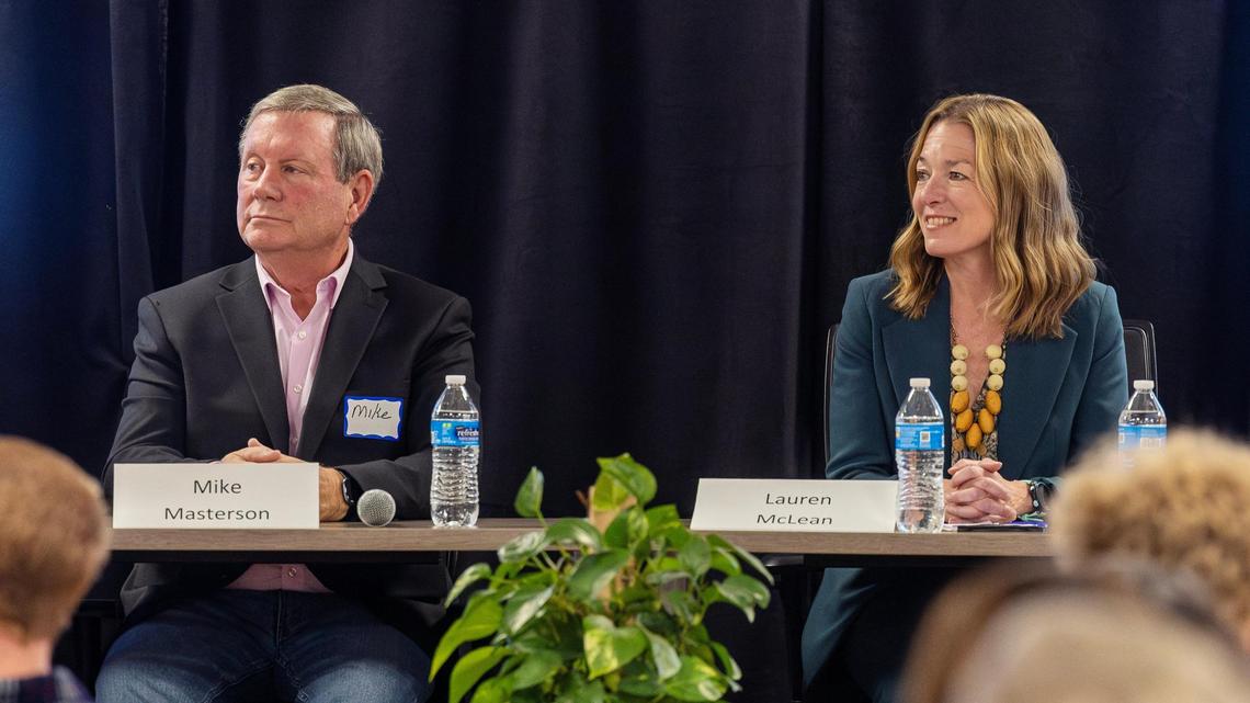 Boise mayoral candidate Mike Masterson and Mayor Lauren McLean listen to the moderator at the start of a debate Wednesday hosted by Boise Young Professionals at Trailhead in downtown Boise.