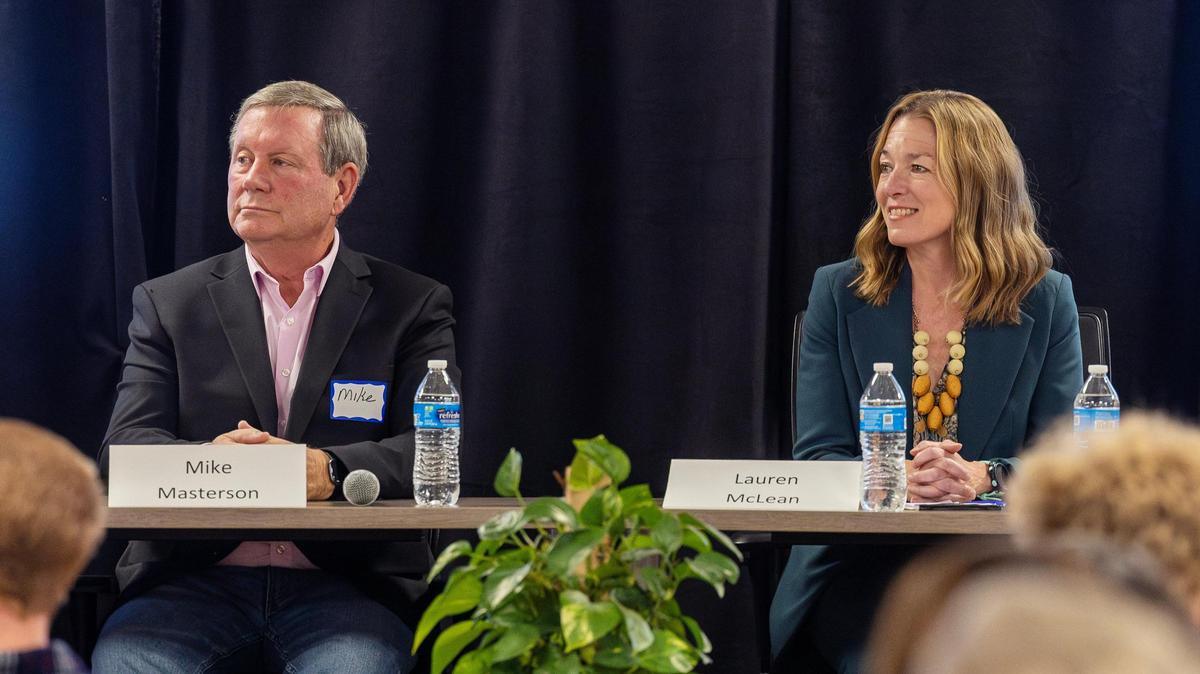 Boise mayoral candidate Mike Masterson and Boise Mayor Lauren McLean listen to the moderator at the start of a debate hosted by Boise Young Professionals at Trailhead in downtown Boise, Wednesday, Oct. 25, 2023.