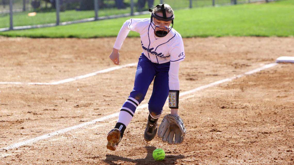 Timberline third baseman Kim Wicker scoops up a slow roller but doesn’t have time to make a throw to first base against Kuna on Thursday at Timberline High.