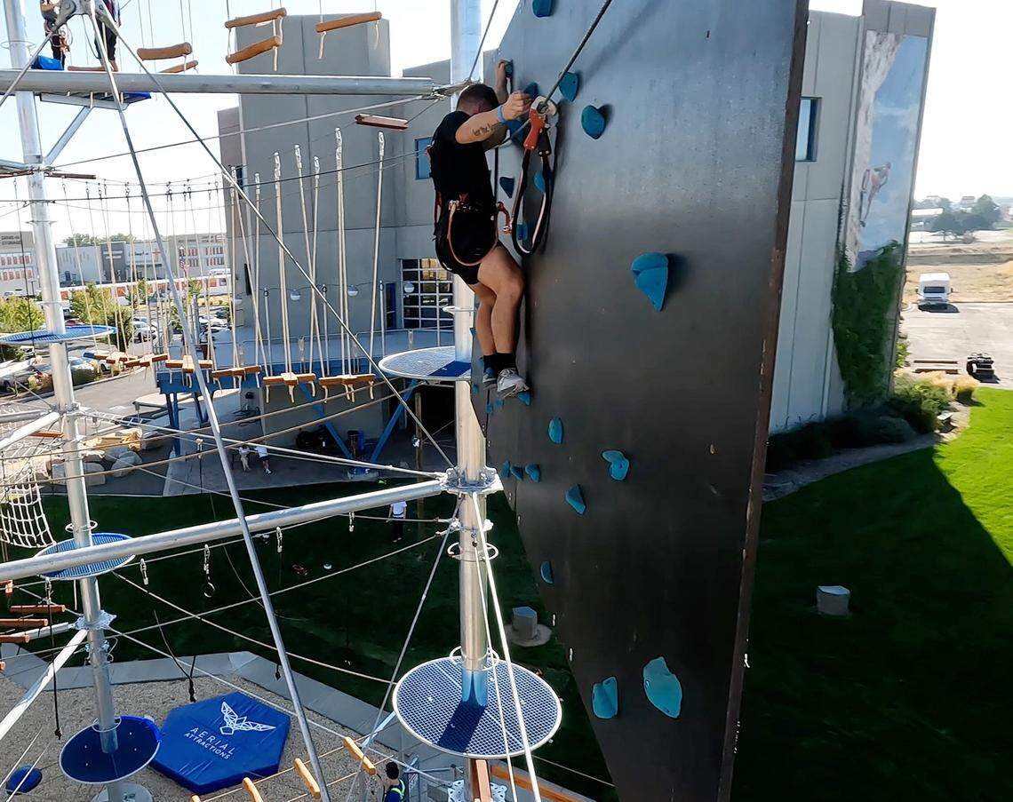 Gavin Gard goes across a rock wall at Vertical View's new four-level outdoor ropes course in Meridian, Aug. 22, 2025.
