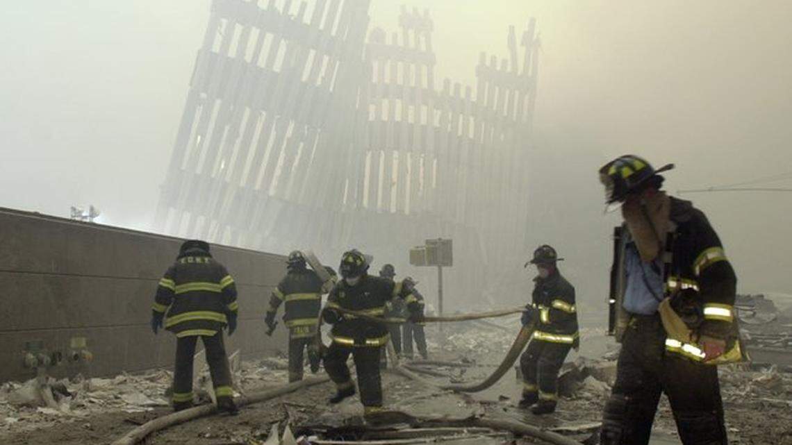 Firefighters work beneath the destroyed mullions, the vertical struts, of the World Trade Center’s twin towers after a terrorist attack in New York on Sept. 11, 2001.