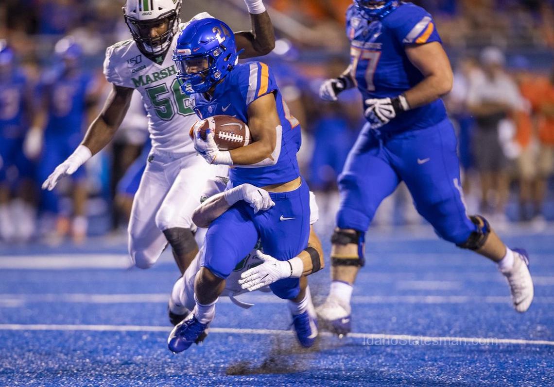 Boise State running back George Holani runs for a gain before being tackled by Marshall linebacker Tyler Brown on Sept. 6 at Albertsons Stadium.