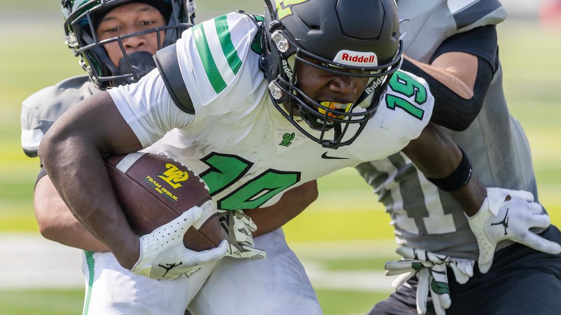 Eagle defensive back Zayah Wright, left, tackles West Linn wide receiver Danny Wideman in the first half Saturday.