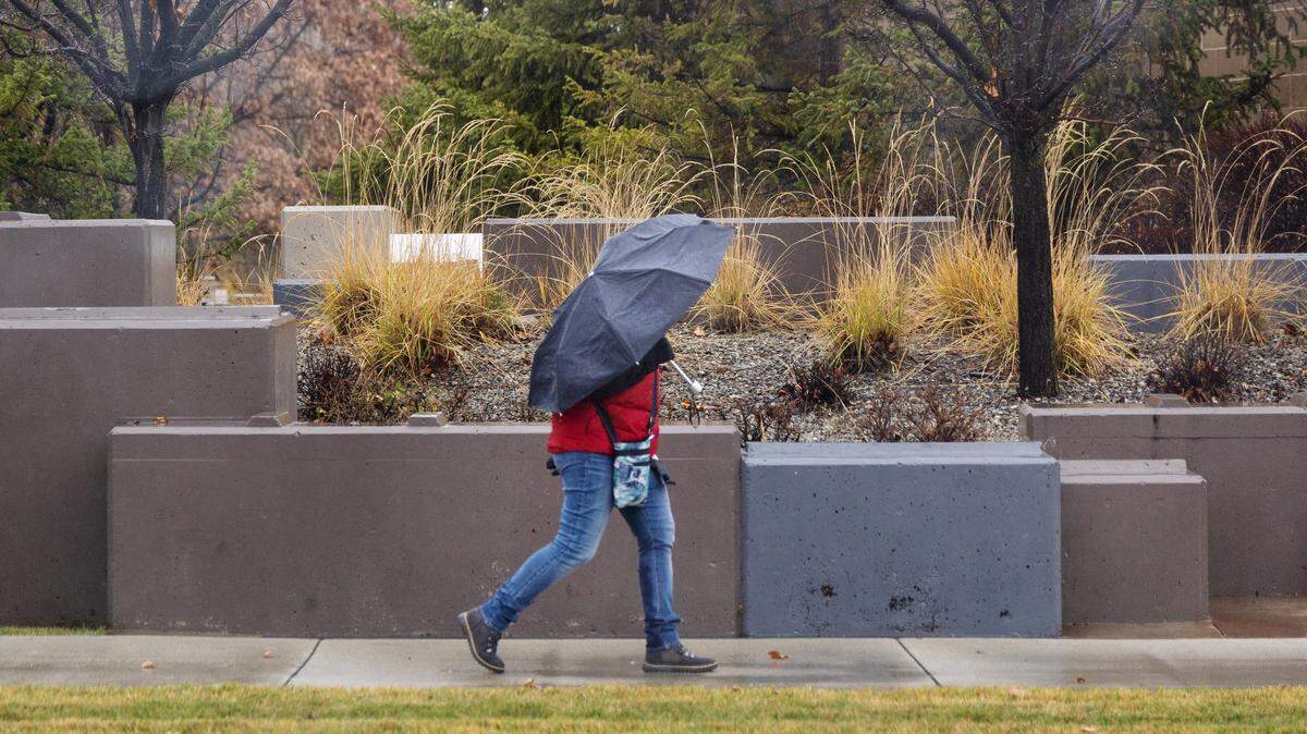 A woman uses an umbrella in the rain. Boise saw nearly an inch of rain on Sunday.