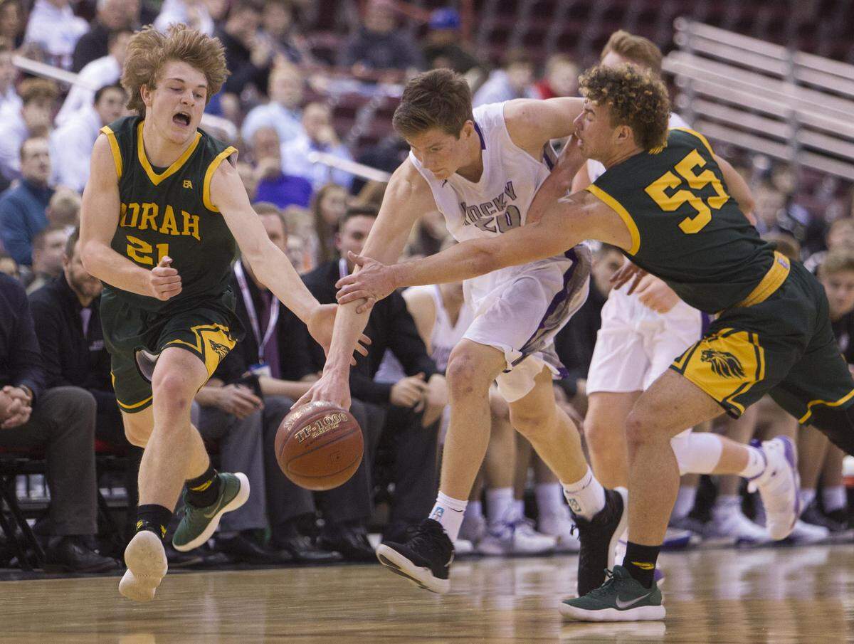 Rocky Mountain’s Briggs Ranstrom dribbles through Borah defenders Jay Ahlstrom and Ellis Magnuson in last season’s 5A state semifinals at the Ford Idaho Center in Nampa.