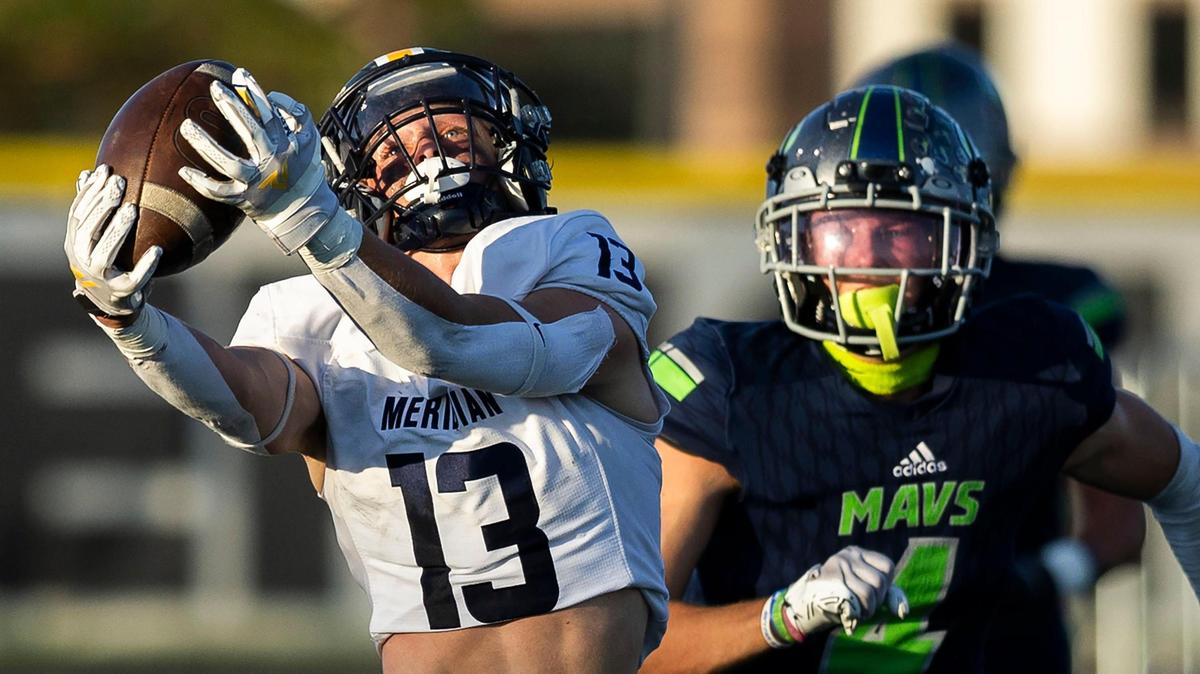 Meridian wide receiver Parker Bunderson hauls in a a 34-yard catch while defended by Mountain View’s Garrett Freeman on Aug. 25. Mountain View won the first matchup 31-26, and the two rivals meet again in the 5A state quarterfinals Friday.