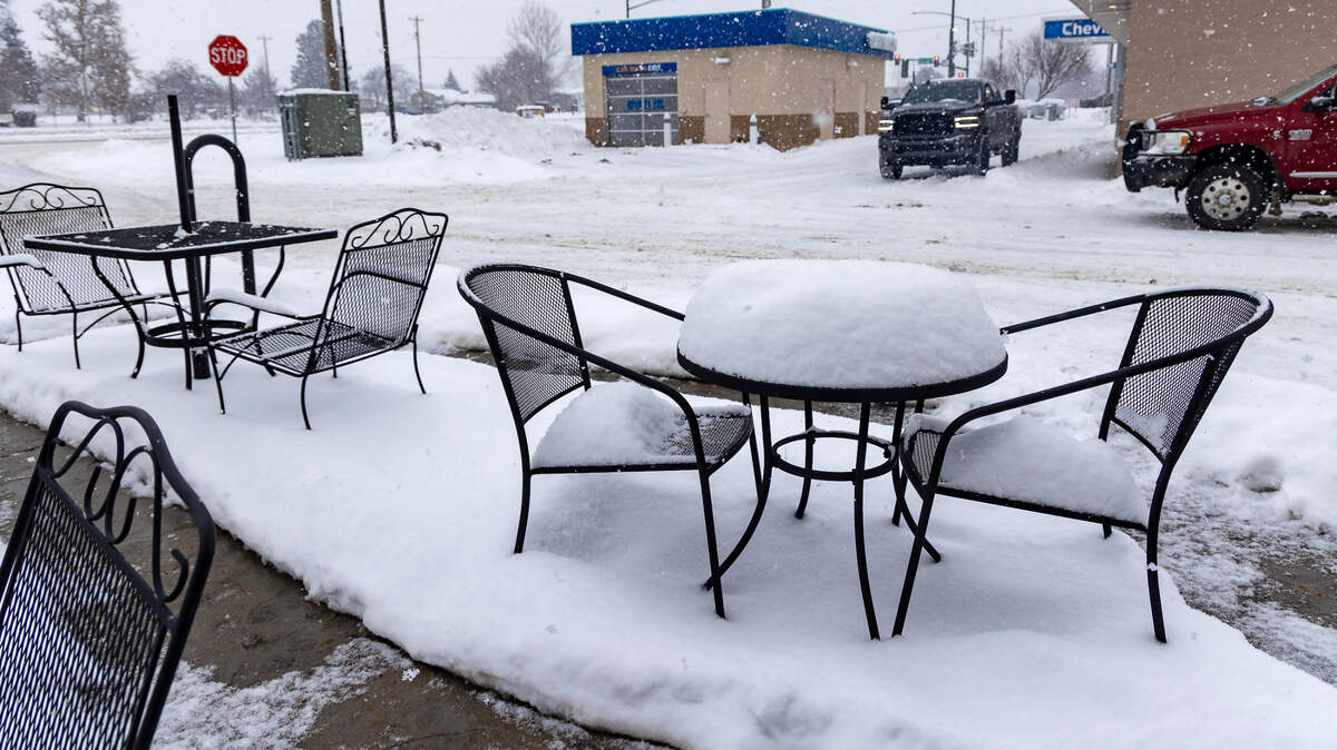 Snow covers a patio table outside of the Moxie Java coffee shop in Kuna, Wednesday, Jan. 17, 2024. A snowy, wet, wintry mix fell in the Boise area Wednesday afternoon.