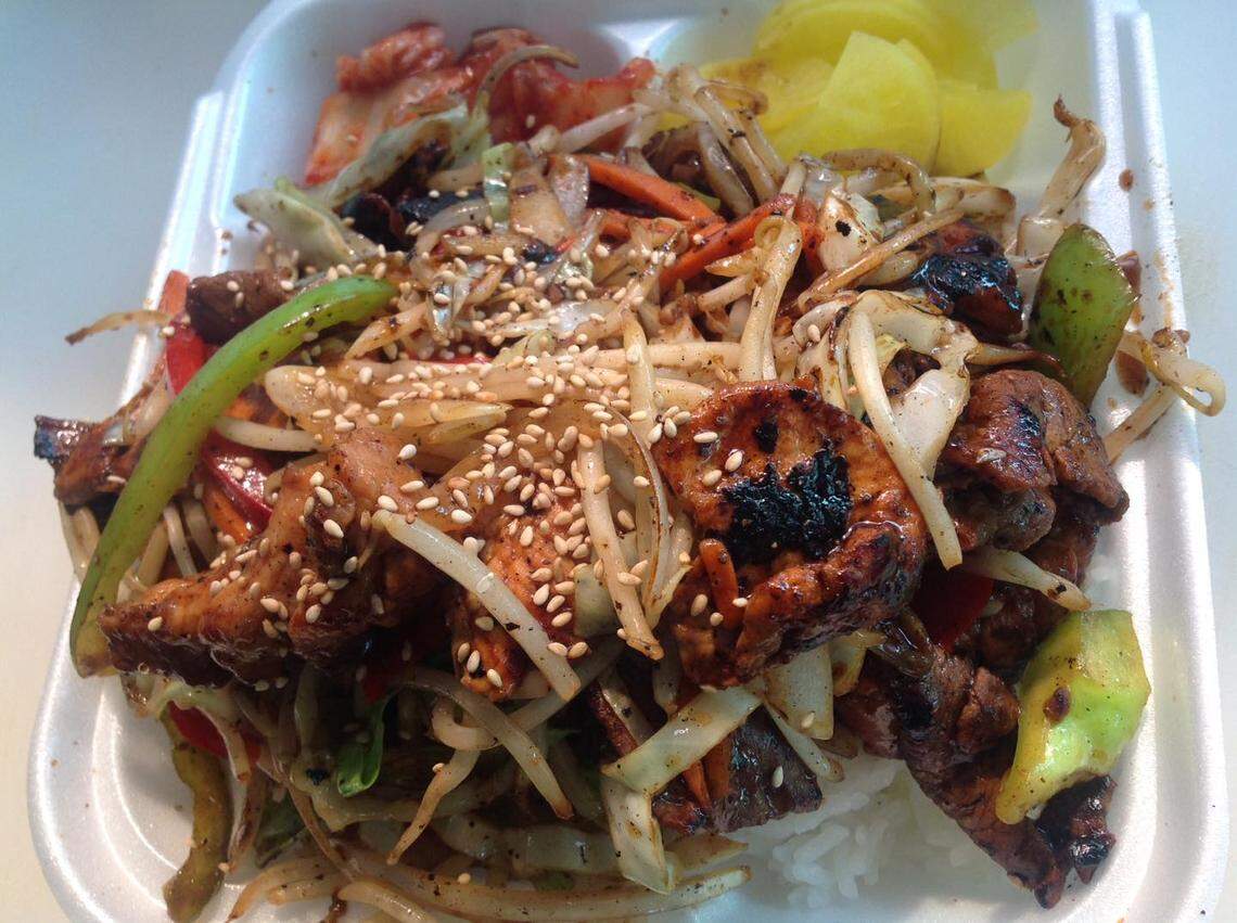 BBQ boxes such as this combination of bulgogi, pork and chicken are popular at Koco Bell. They always come with traditional Korean tea.