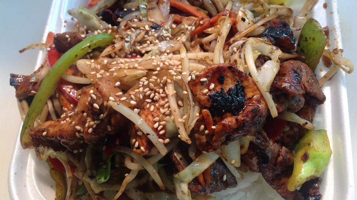 BBQ boxes such as this combination of bulgogi, pork and chicken are popular at Koco Bell. They always come with traditional Korean tea.