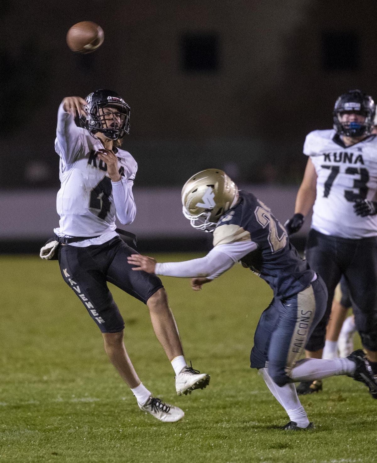 Kuna quarterback Sean Austin completes a under pressure from Vallivue’s Tanner Buckley last week.