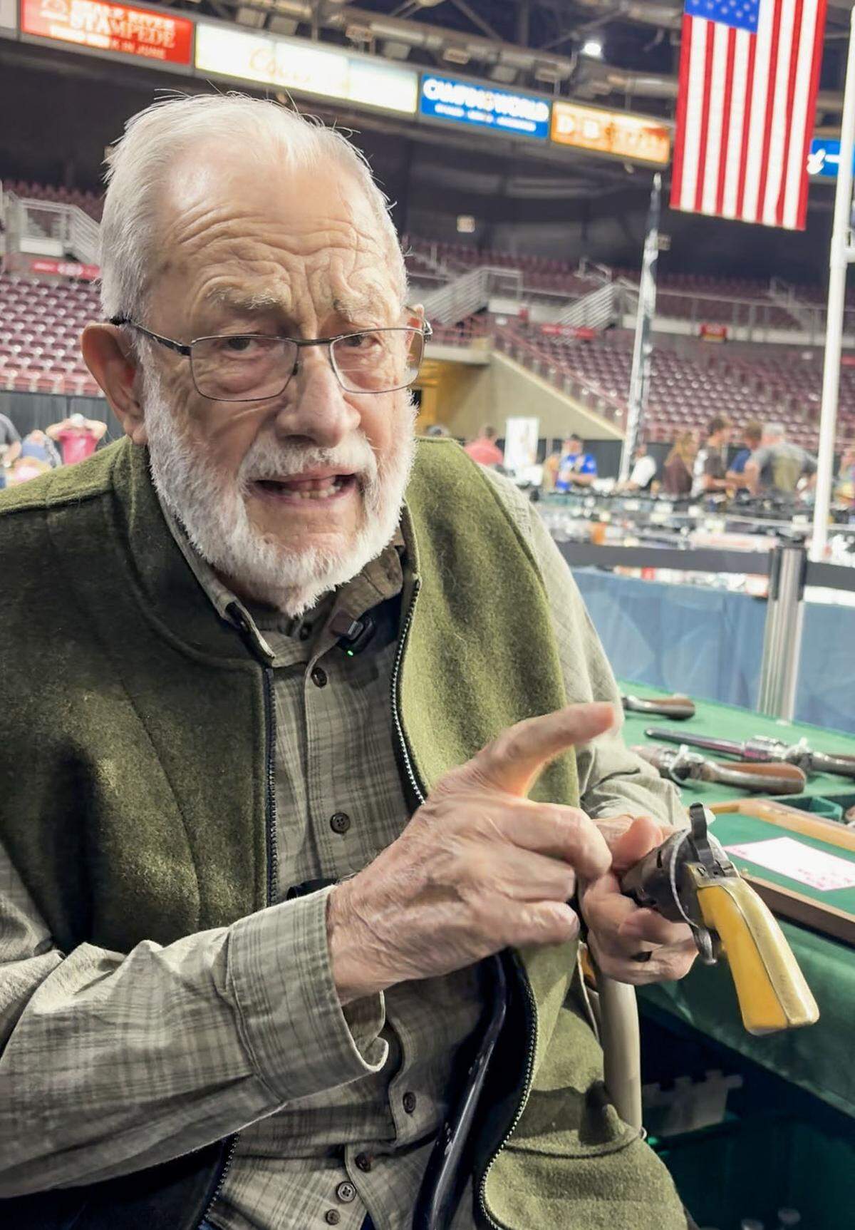 Paul Snider, 89, explains that all guns at The Great Idaho show are required to be zip tied to prevent loading. 