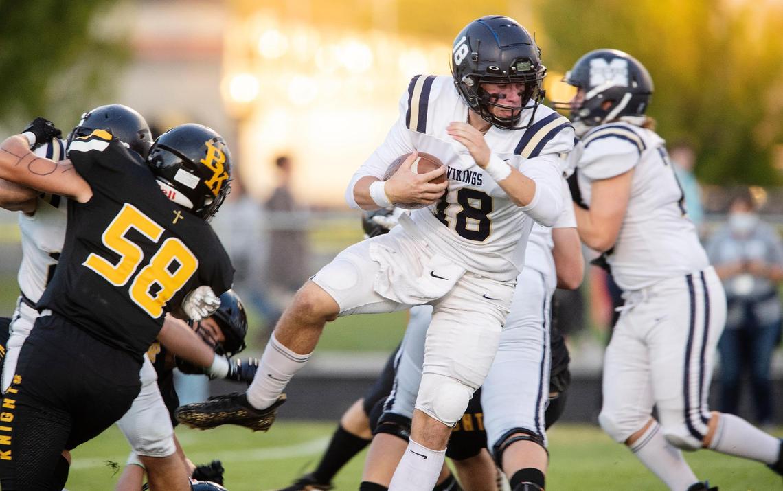 Middleton quarterback Ky McClure pushes forward for extra yards at Bishop Kelly on Oct. 1.