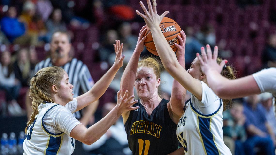Bishop Kelly’s Mary Behrend is surrounded by Middleton defenders in the 5A District Three girls basketball championship game last week at Idaho Central Arena in Boise.