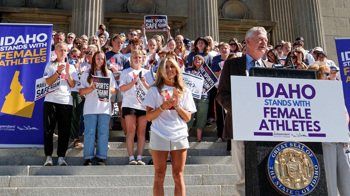 Joined by Riley Gaines, a former swimmer at the University of Kentucky who has sued the NCAA, Idaho Gov. Brad Little touts his executive order, called the Defending Women’s Sports Act, on the Capitol steps in late August.