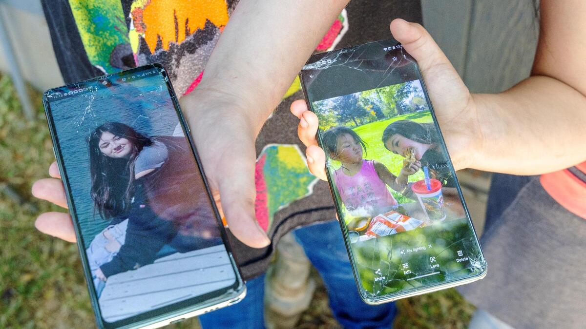 Photos of Alyssa are held by two of her siblings outside of their Boise home Thursday.