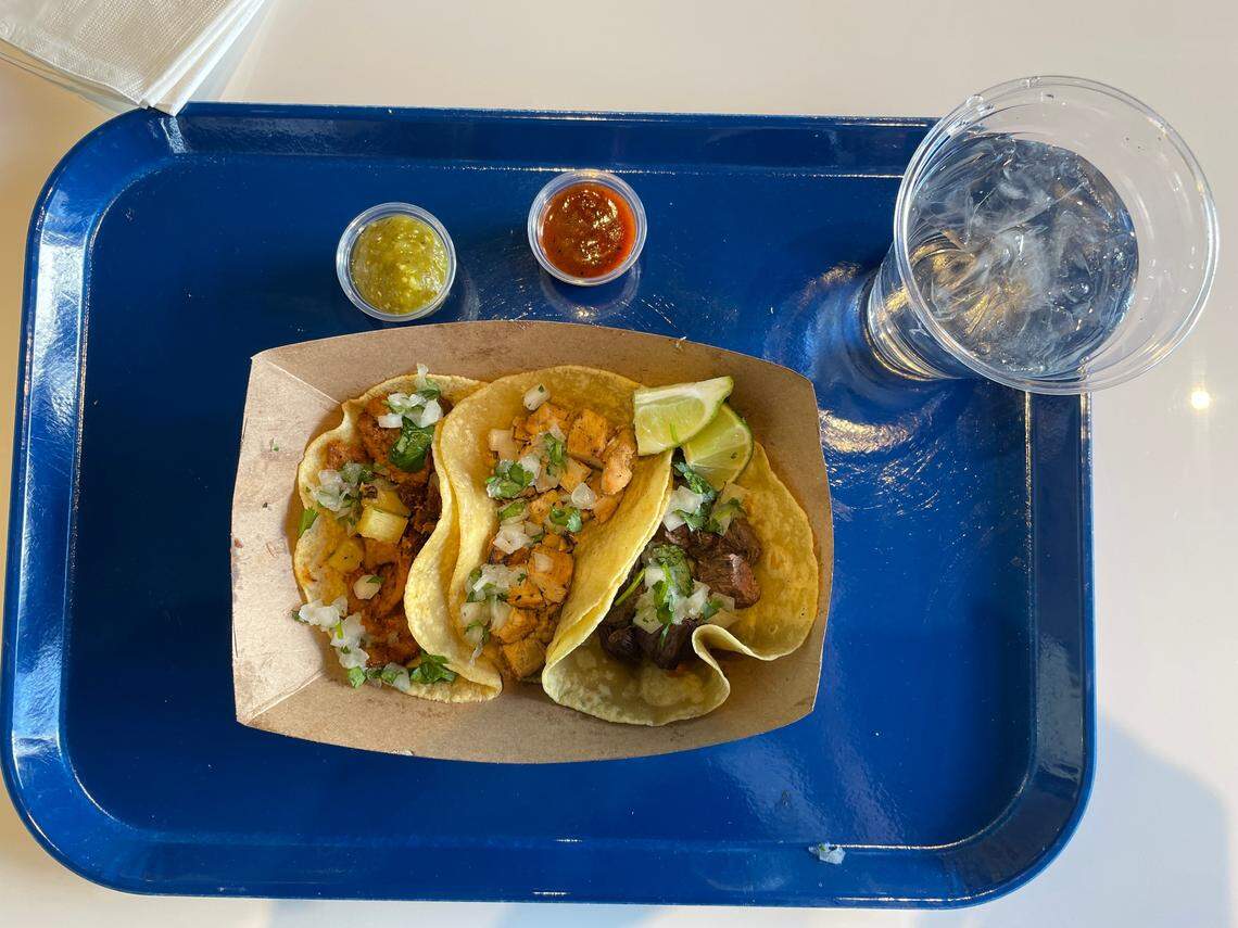 Tacos are served no-frills-style, in a cardboard container on a tray, at Rosa. From left, al pastor, chicken and skirt steak.