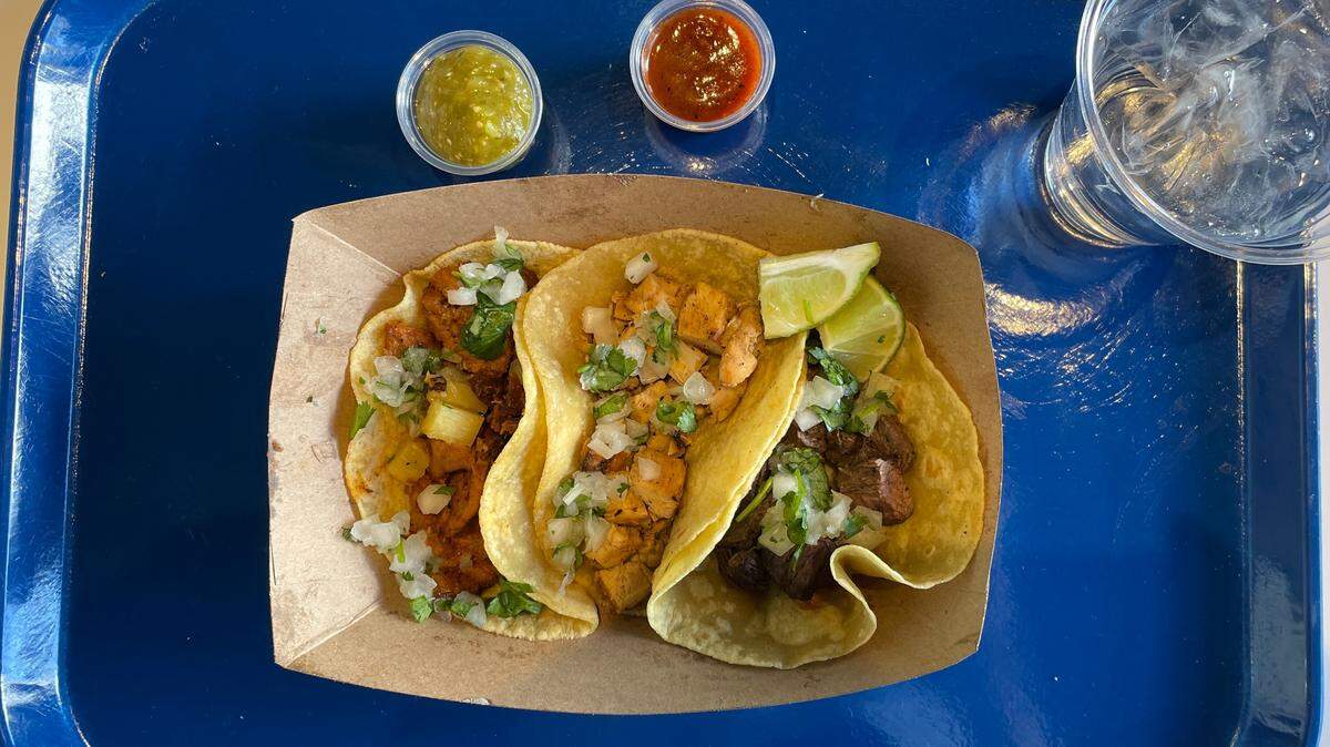 Tacos are served no-frills-style, in a cardboard container on a tray, at Rosa. From left, al pastor, chicken and skirt steak.