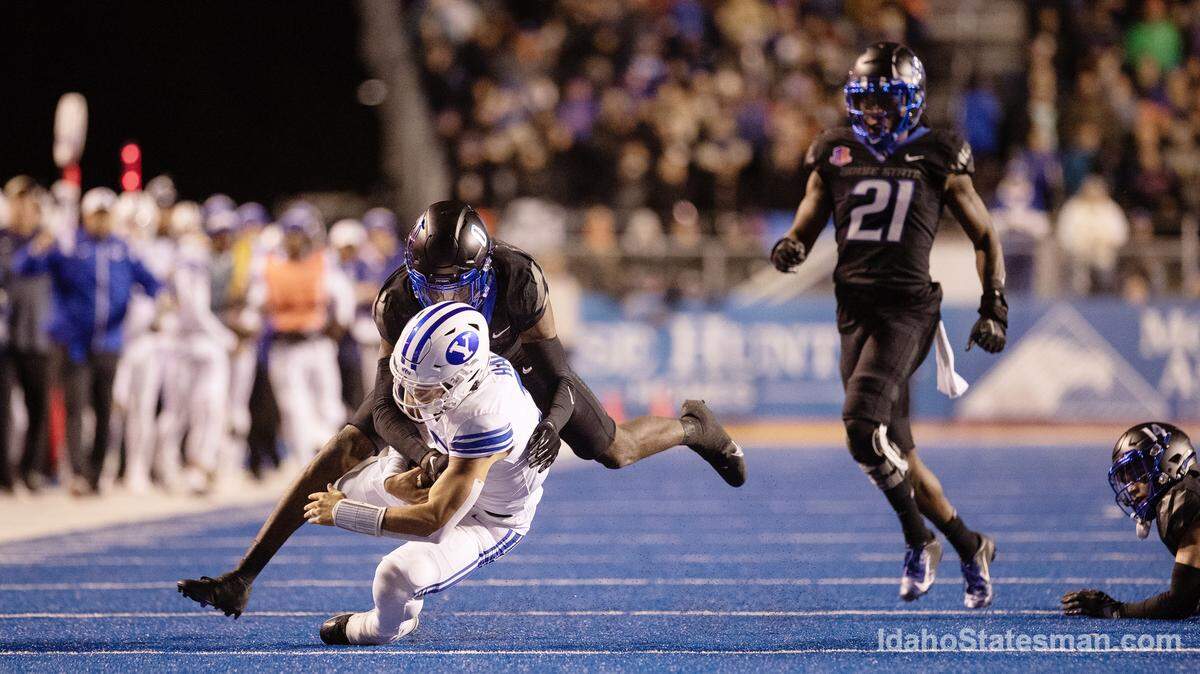 Boise State safety JL Skinner brings down BYU quarterback Jaren Hall with nickel Tyreque Jones (21) in tow during the Broncos’ loss to BYU in November 2022. Skinner and Jones have been invited to the NFL Scouting Combine.