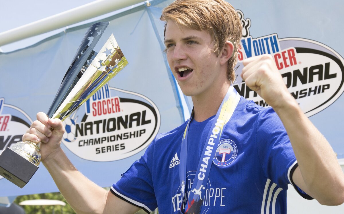 Boise Nationals forward Braden Anderson flexes with the U-16 boys state title trophy Monday at the Simplot Sports Complex.