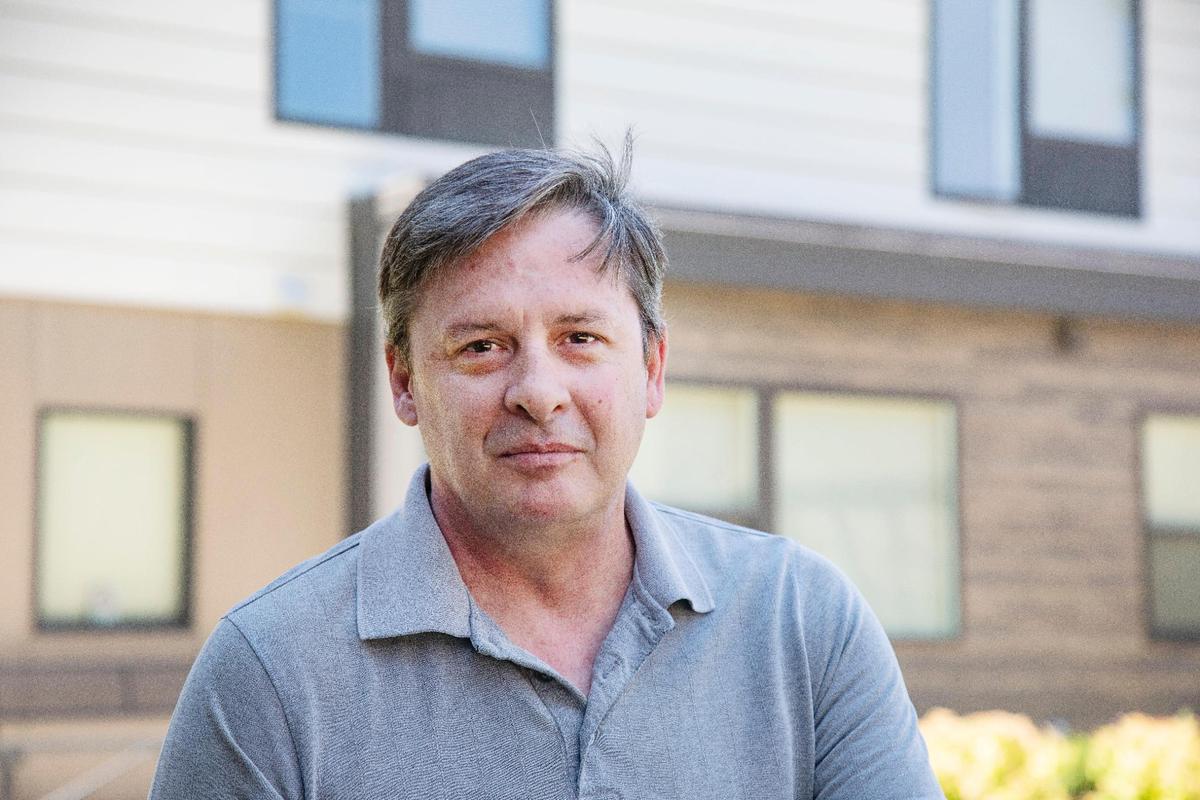 David Hall sits in the courtyard at New Path Community Housing. Hall has been a resident at New Path since 2019. Before that, he was homeless for seven years.