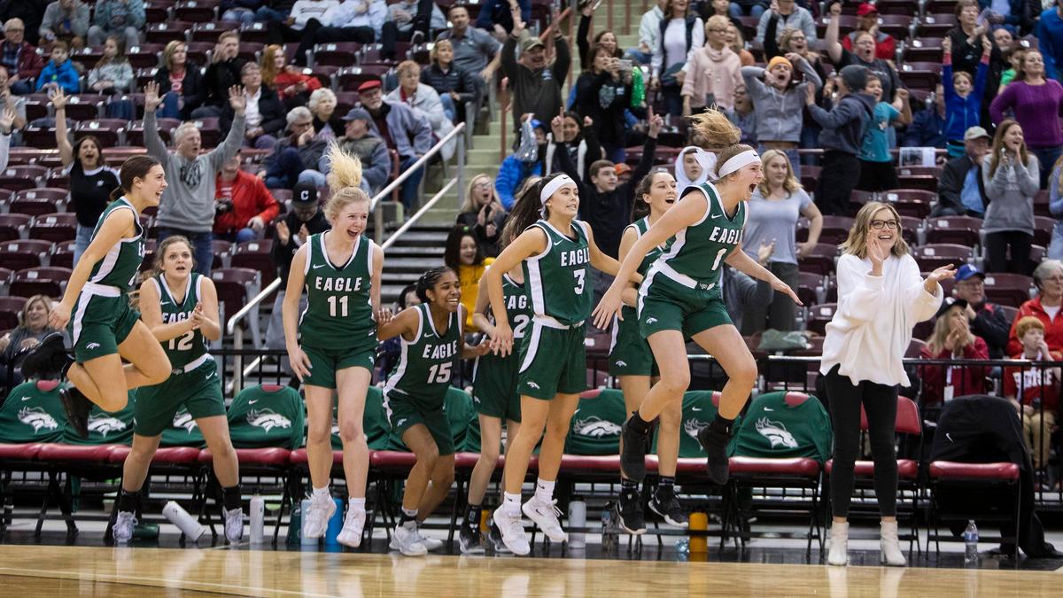 Eagle’s bench celebrates a 50-49 upset win over Coeur d’Alene in the first round of the 5A girls basketball state tournament Thursday at Ford Idaho Center in Nampa.