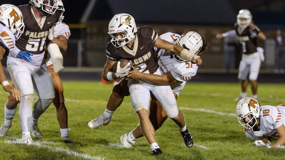 Vallivue senior running back Onix Carson is stopped by Ridgevue senior lineman Timote Manusina during their game at Vallivue High School in Caldwell, Friday, October. 3, 2025.