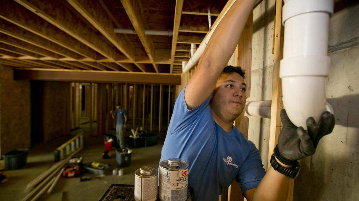Matt Medrano works on a plumbing project in Boise with Ediger Plumbing in June 2014. Plumbers are among the many occupations the state of Idaho regulates through licensing.