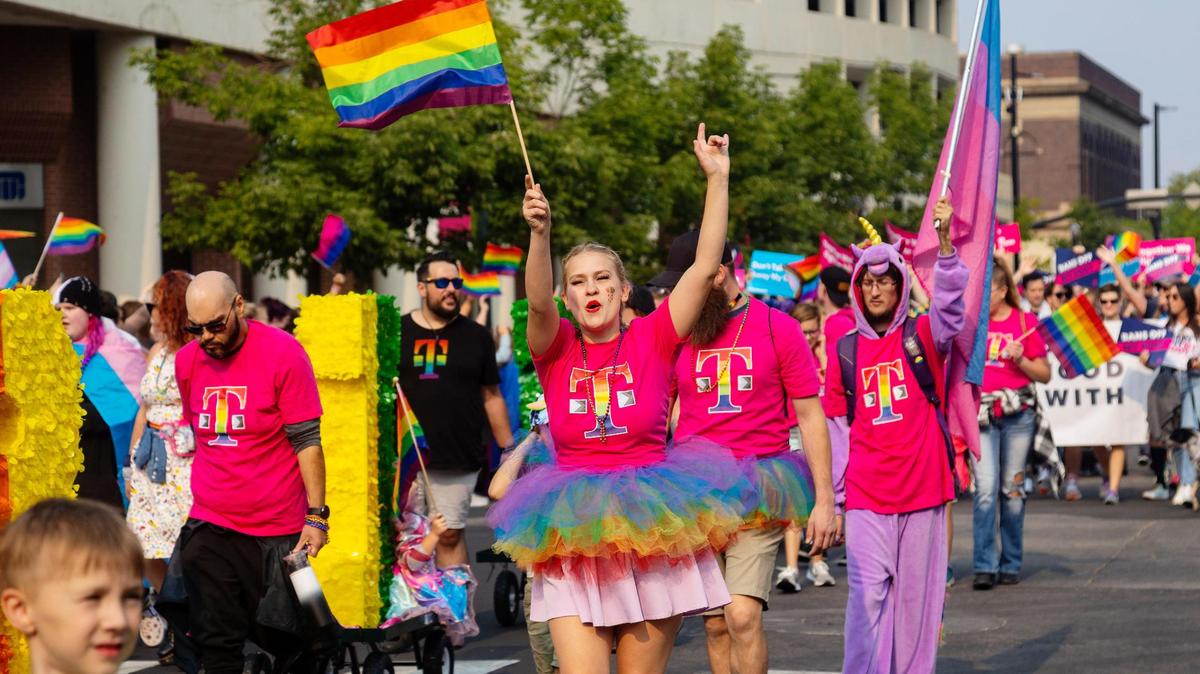 People wearing T-Mobile attire walk in the parade for Boise Pride Festival on Sunday, Sept, 11, 2022. The Fred Meyer Pride Parade circled through downtown Boise with nearly 70 entries ranging from small organizations walking to corporate floats.