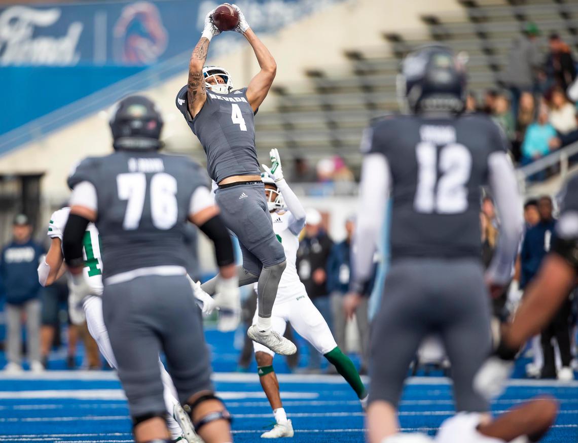 Nevada wide receiver Elijah Cooks (4) rises above the Ohio defense for a first down catch delivered by quarterback Carson Strong (12) in the final minutes of the first half of the Famous Idaho Potato Bowl Friday, Jan. 3, 2020 at Albertsons Stadium in Boise.
