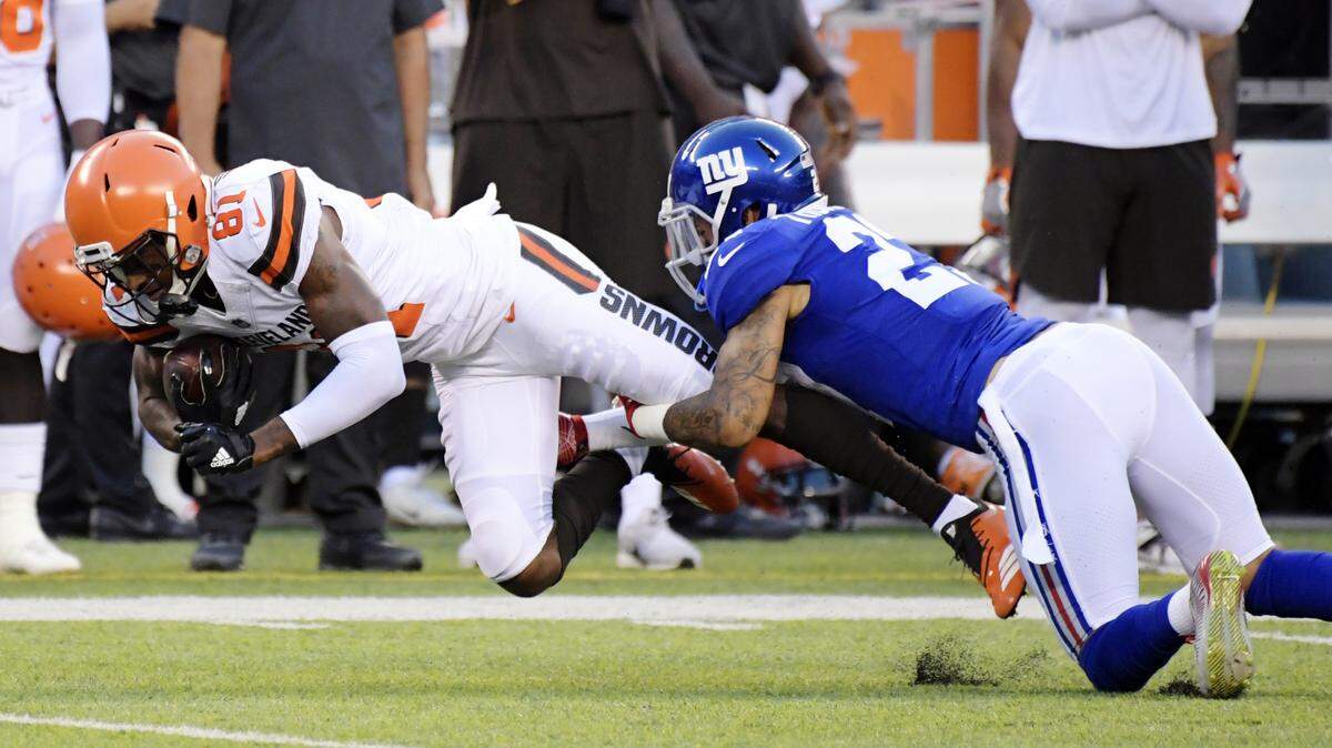 The Cleveland Browns’ Rashard Higgins is tackled by the New York Giants’ Darian Thompson during a preseason game Aug. 9, 2018, in East Rutherford, N.J.