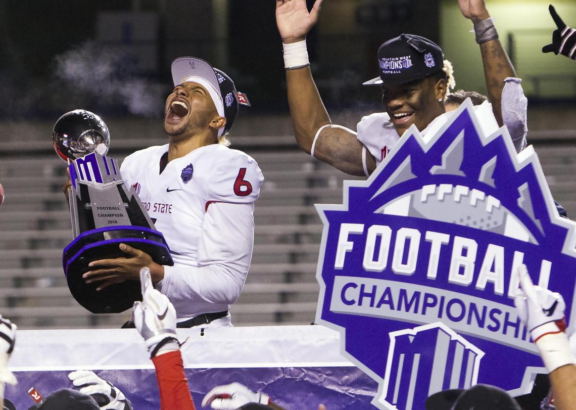 Fresno State quarterback Marcus McMaryion (6) celebrates with the Mountain West Conference Championship trophy after the Bulldogs defeated Boise State 19-16 in overtime Saturday, Dec. 1, 2018 at Albertsons Stadium in Boise.