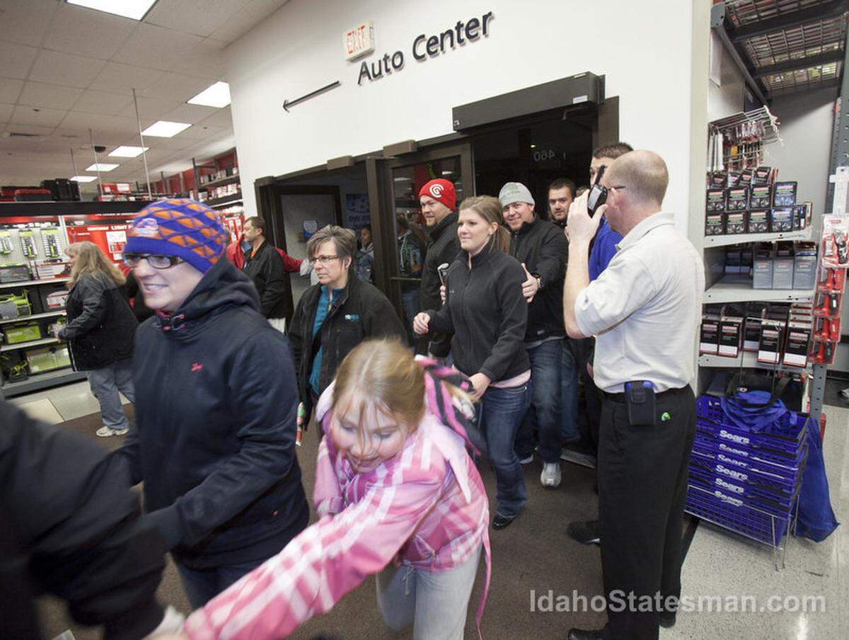 People rush into Sears at the Boise Towne Square Mall Thursday Nov. 22, 2012. About 300 people waited outside the store for the chance to shop when it opened at 8 P.M. Thursday.