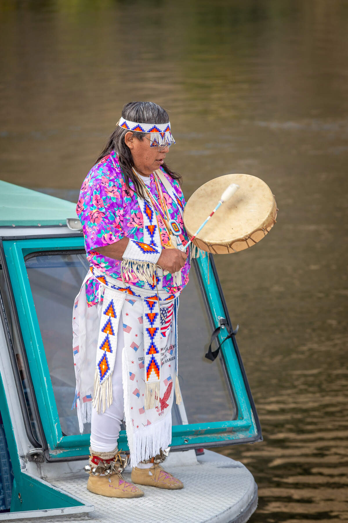 The Nimiipuu elder sings and drums during the tour.