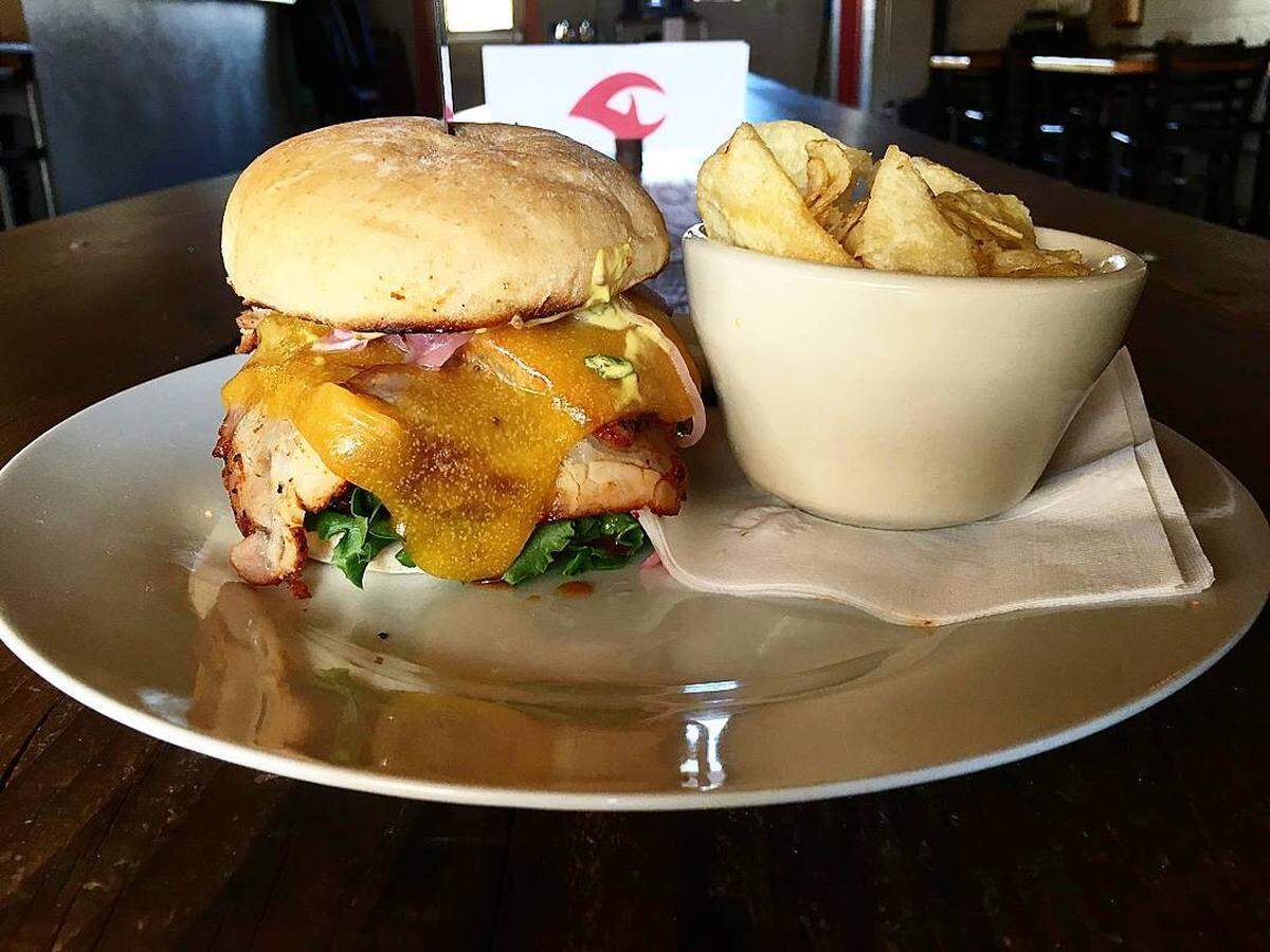 The Bunyan Burger at Side A Brewing with smoked pork loin, Corriente beef, zesty mustard sauce, Tillamook cheddar, lettuce and pickled onions.