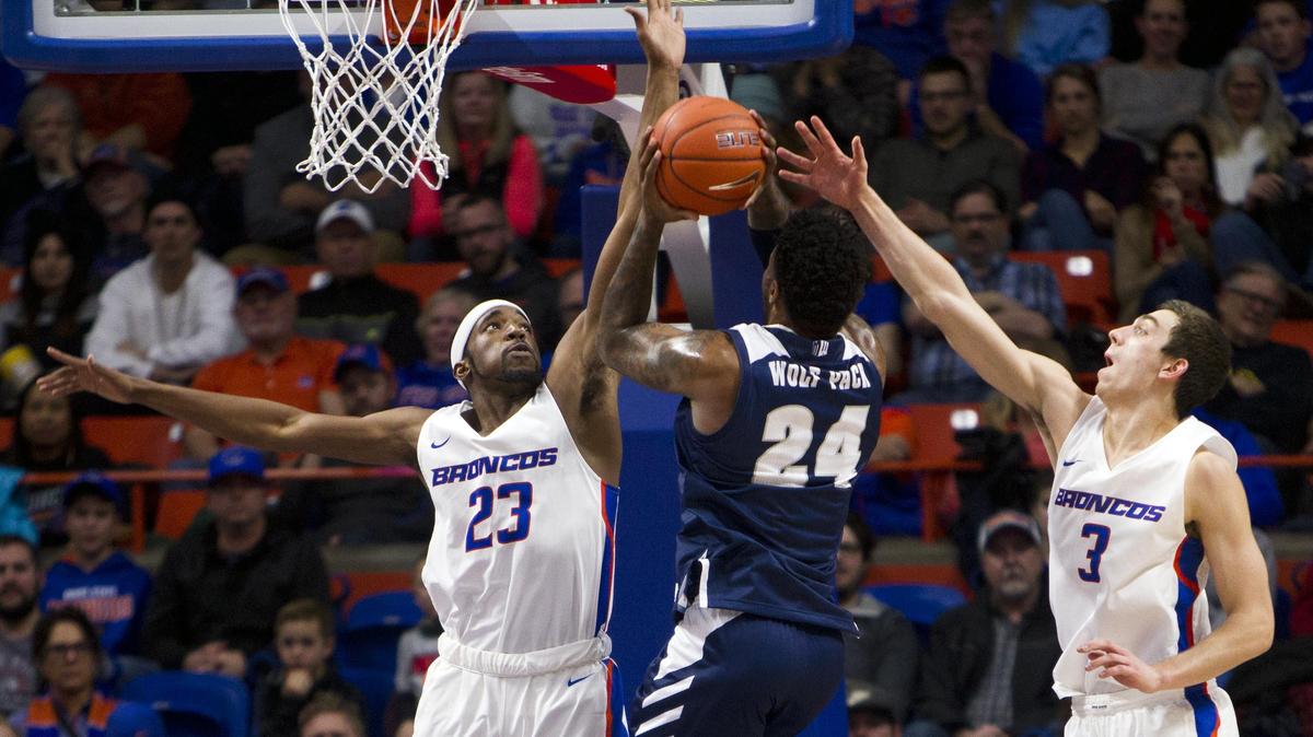 Boise State guard RJ Williams challenges a shot by Nevada’s Jordan Caroline with help from teammate Justinian Jessop (3) Tuesday, Jan. 15, 2019 at Taco Bell Arena in Boise.