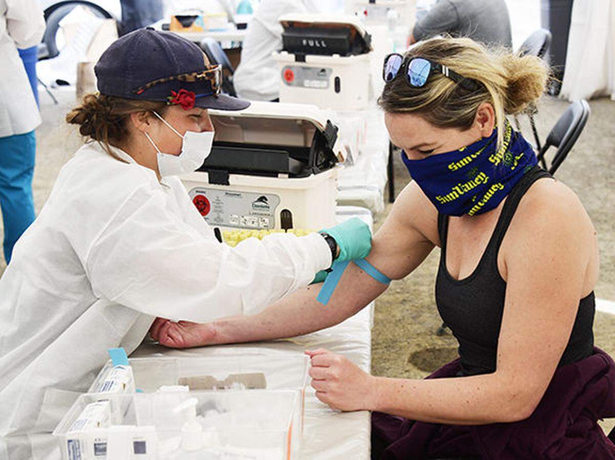 A woman receives a coronavirus antibody test at a mobile medical tent in Ketchum on Monday, May 11, 2020.