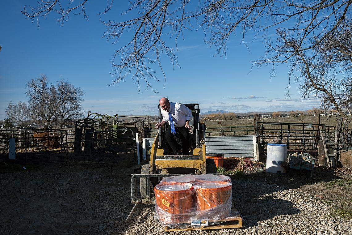With is tie and dress shirt still on, Rep. Mike Moyle, R-Star, gets out of the cab of his compact track loader after unloading a pallet of protein blocks for his cattle on his ranch in Star. Moyle, the House majority leader, was able to find time between meetings to make a trip to Caldwell to buy pneumonia shots and other medicine for cattle on this day, March 3, the height of calving season on his farm.