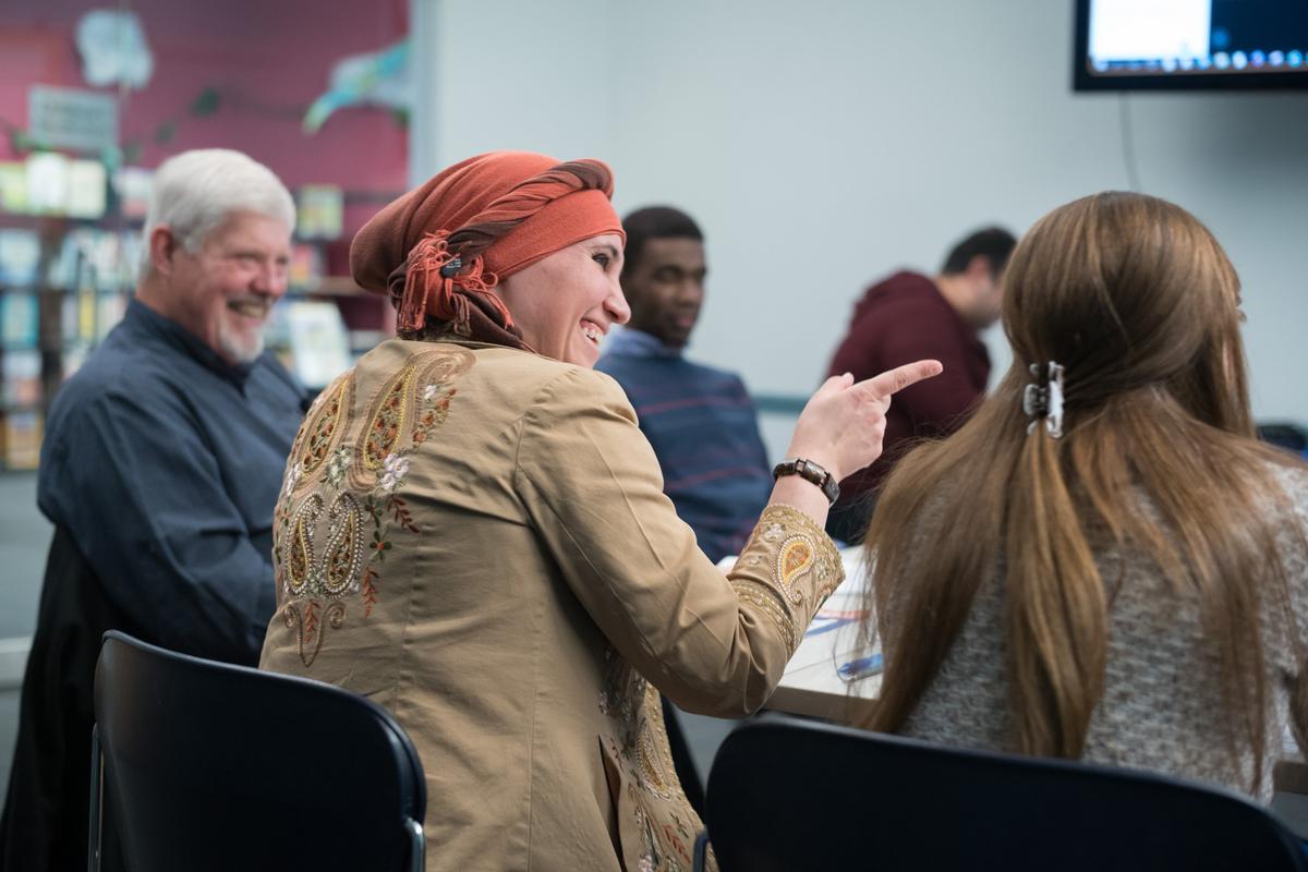 Dr. Dhuha Ali jokes with a fellow physician during a study session. Ali’s father discovered the first treatment for HIV while studying in England, and Ali is among a group of refugee physicians studying to become licensed in the U.S.