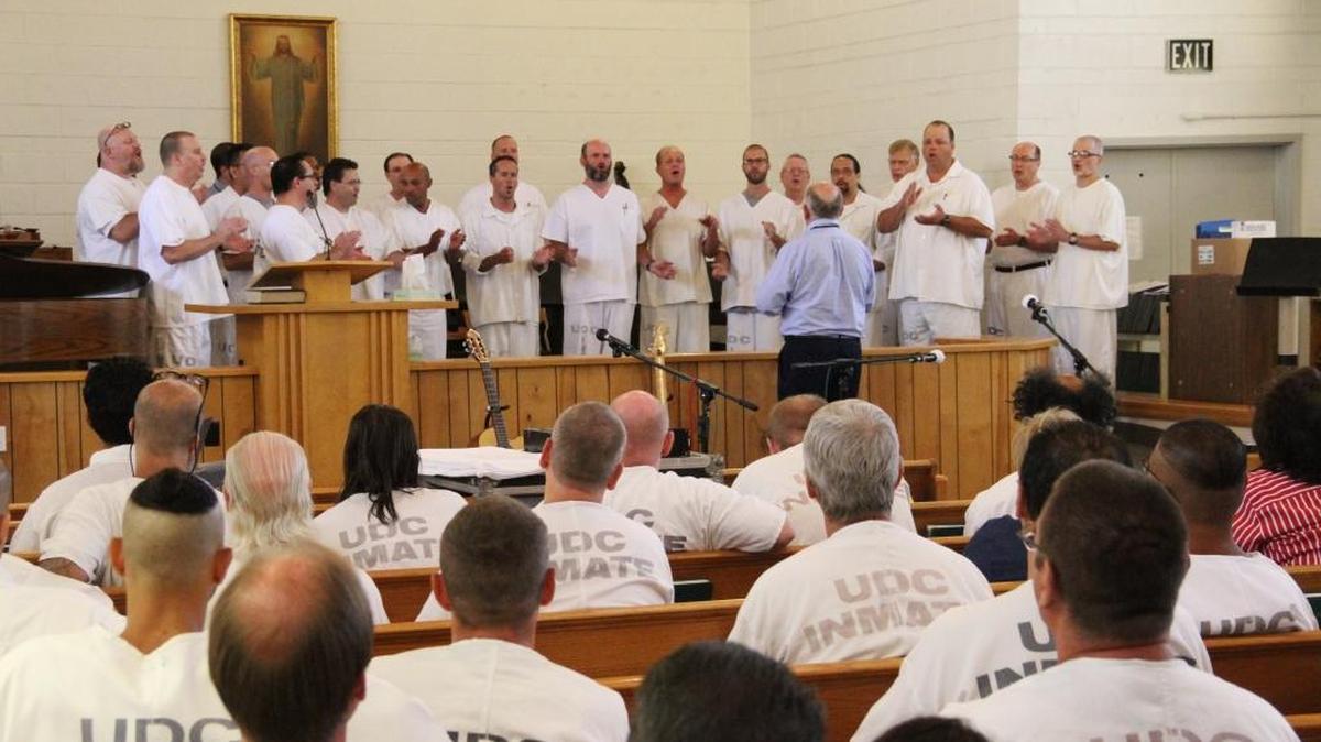 Under the direction of Mormon Tabernacle Choir director Mack Wilberg, members of the Wasatch Music School’s advanced vocals group perform “Child of God” and “River in Judea” at the Utah State Prison.
