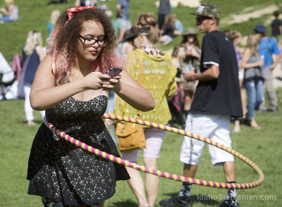 Amanda Hawks, 17, tries out a demonstration hula hoop from Boise Hoopla while using her phone at the Hyde Park Street Fair. “My favorite part of the fair is definitely music,” she said. The three-day fundraising fair, sponsored by the North End Neighborhood Association, features music, food, beer, shopping and a kids’ play area. The 2020 fair was canceled because of the coronavirus pandemic. It’s scheduled to return Sept. 17 to 19.