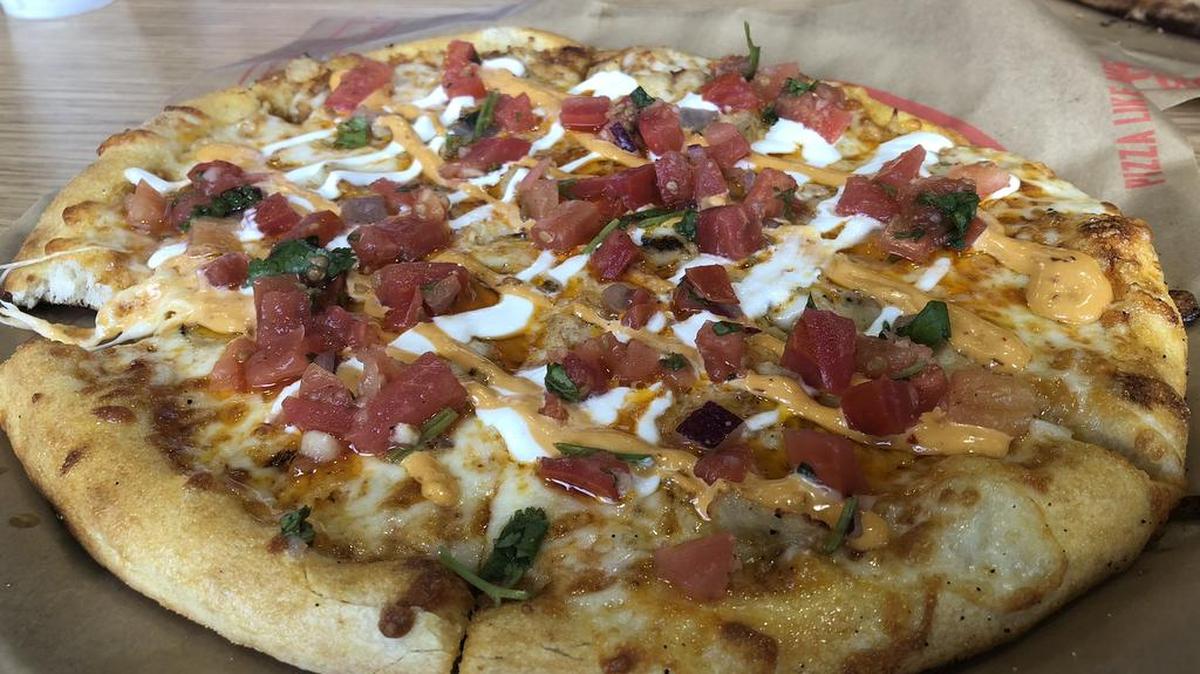 The chipotle chicken pizza at Firenza has chipotle sauce, mozzarella, chicken, crema, chipotle dressing and fresh pico de gallo.