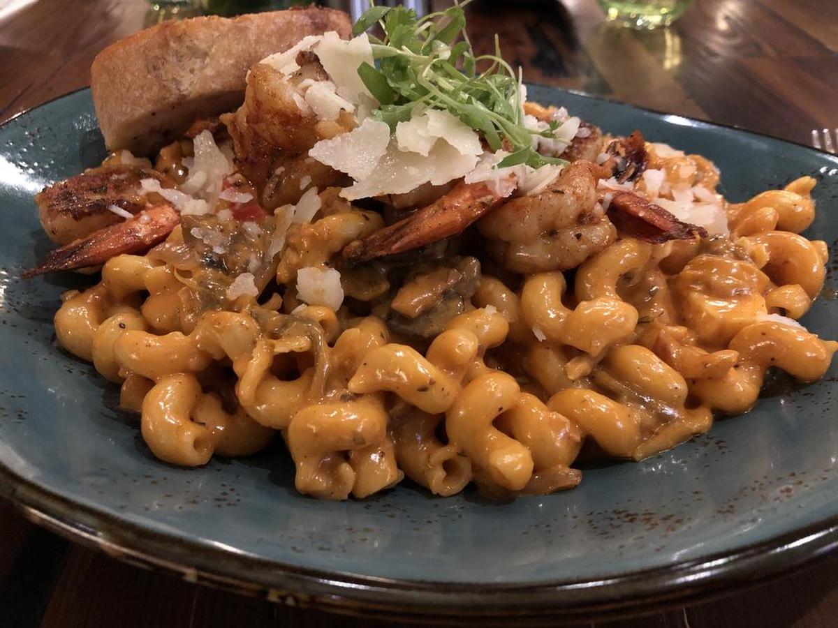 Trillium’s cajun shrimp dish is topped with spicy asiago cream, cheese curds, peppers, onions and wild mushrooms.