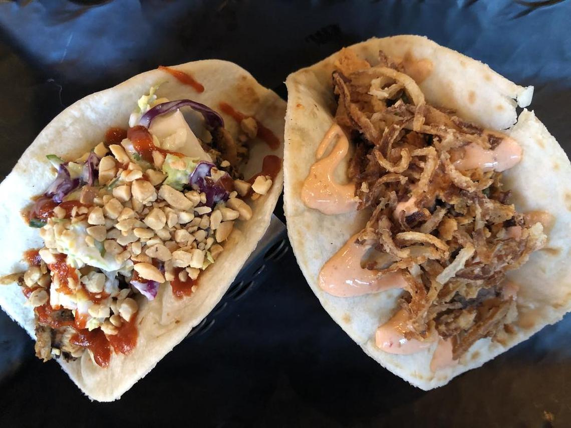 The refreshing Thai-tanic taco, left, features chicken, slaw and plenty of crushed peanuts. El Torro tops flavorful steak with jalapeno chimichurri, chipotle crema and onion straws.